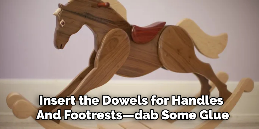 Insert the Dowels for Handles 
And Footrests—dab Some Glue