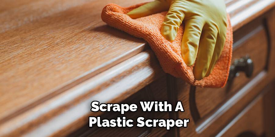 Scrape With A
Plastic Scraper