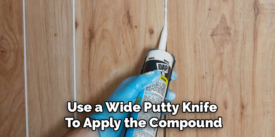 Use a Wide Putty Knife 
To Apply the Compound